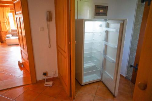 a kitchen with an empty refrigerator in a room at Chalupa Lužické hory in Dolní Světlá