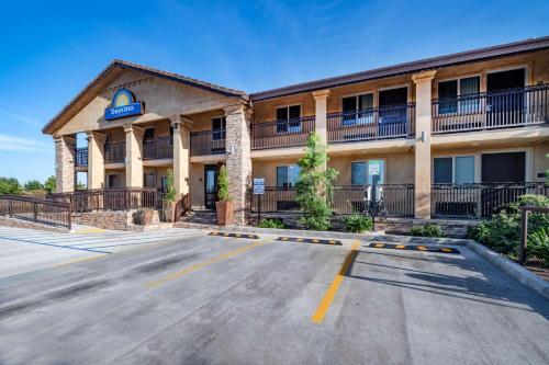 a front view of a hotel with a parking lot at Days Inn by Wyndham Galt - Elk Grove South in Galt