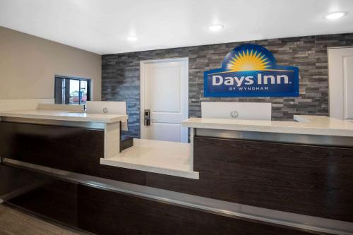 a day inn sign on a brick wall at Days Inn by Wyndham Galt - Elk Grove South in Galt