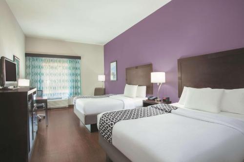 a hotel room with two beds and a television at La Quinta by Wyndham Fort Walton Beach in Fort Walton Beach