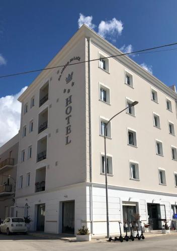 a white building with a sign on it at D'Angelo Palace Hotel in Mazara del Vallo