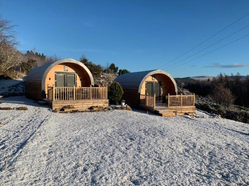 two domes in the snow on a gravel road at Daviot Luxury Pods in Inverness