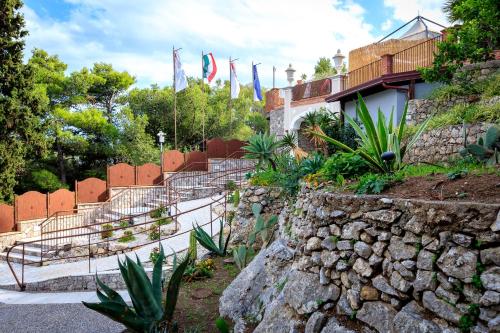 a group of flags are flying in front of a building at Hotel Ariston and Palazzo Santa Caterina in Taormina