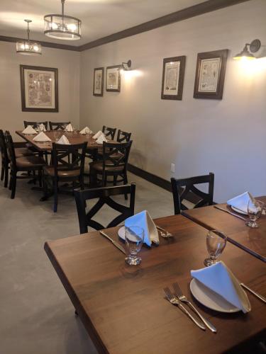 a dining room with wooden tables and chairs at Inn at the Falls in Bracebridge
