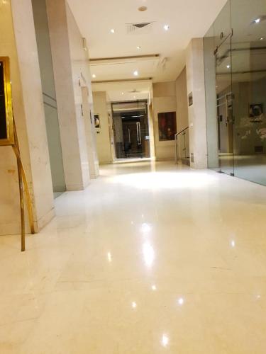 a large room with a large white floor in a building at Udman Hotel Panchshila Park in New Delhi