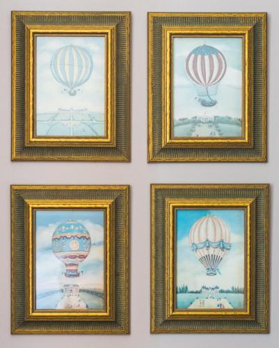 a group of framed pictures of hot air balloons at La Goélette, Chambres d'Hôtes in Wimereux