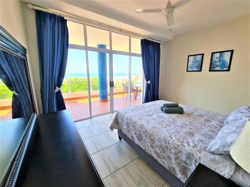 a bedroom with a bed and a large window at Colonial Sands B in Margate