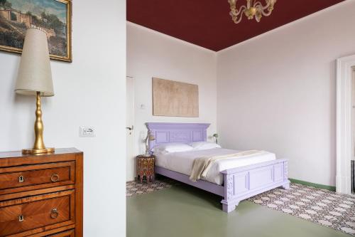 a bedroom with a bed and a lamp and a dresser at Marina Piccola 73 in Sorrento