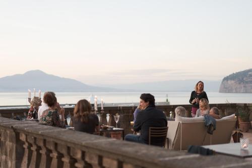 a group of people sitting around a table at Marina Piccola 73 in Sorrento