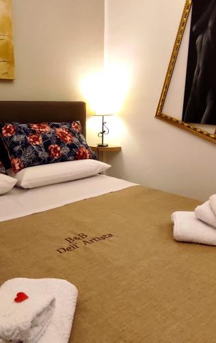 a bedroom with a bed with a pillow with the words happy anniversary at B&B Dell'Artista in Olevano sul Tusciano