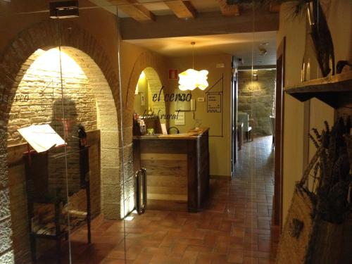 a hallway of a restaurant with a counter in a room at Hotel El Cerco in Puente la Reina