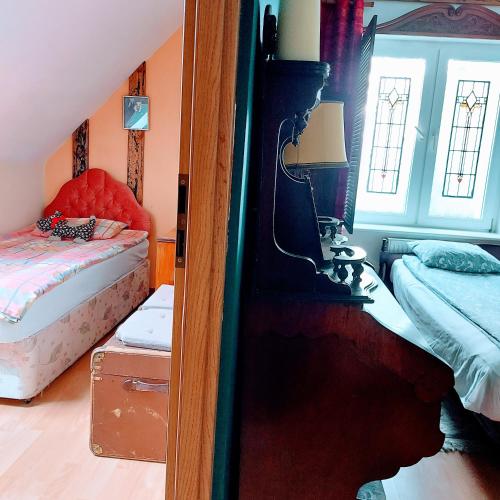 a bedroom with two beds and a mirror in it at Willa Zamkowisko in Gołubie