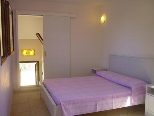 a bedroom with a large bed with purple sheets at Agriturismo Tenuta La Siesta in Gallipoli