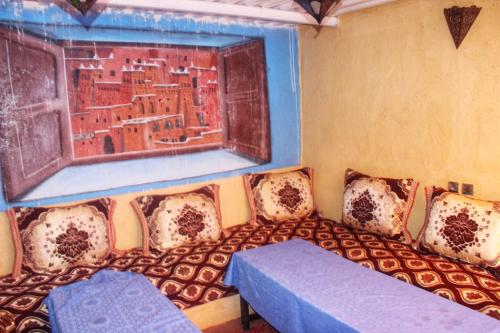 a room with a couch and a window at Auberge et hôtel les amis tafraout in Tafraoute