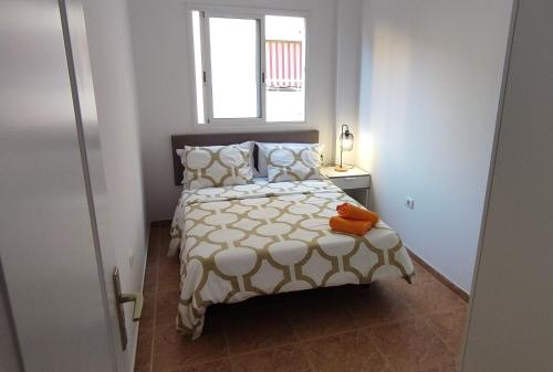 a bedroom with a bed and a window at CASA ROBERTO CANDELARIA,PARKING,AIR,WIFi in Candelaria
