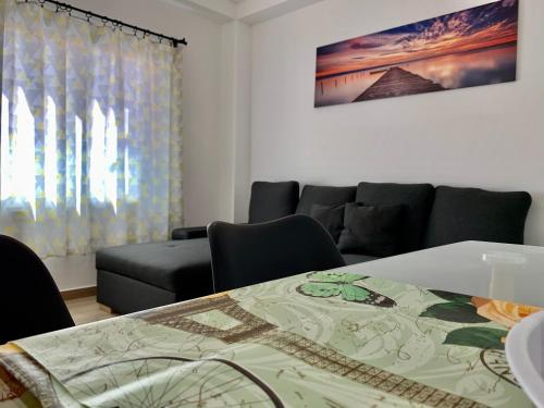 a living room with a table and a couch at Arguineguin Beach Lux Solarium Suit in Arguineguín