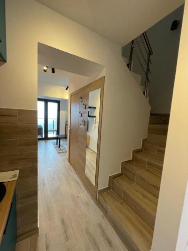 a staircase in a house with a hallway with wooden floors at Divcibarski cardak in Divčibare
