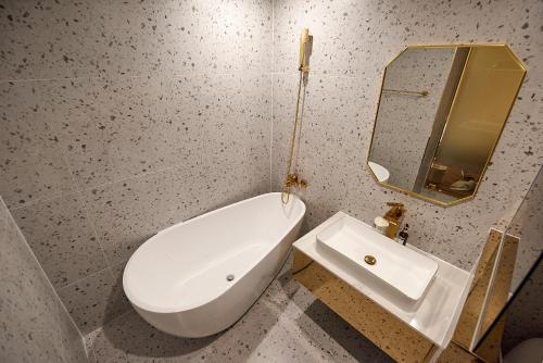 a bathroom with a white toilet and a sink at Denbasta Hotel in Busan