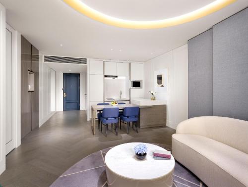 a kitchen and living room with a couch and a table at Sofitel Ambassador Seoul Hotel & Serviced Residences in Seoul