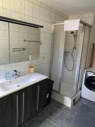 a bathroom with a shower and a sink and a shower at Dorfschenke in Siegen