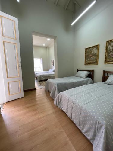 a bedroom with two beds and a door to a room at Del Rocío Alojamiento -ANDES in Los Andes