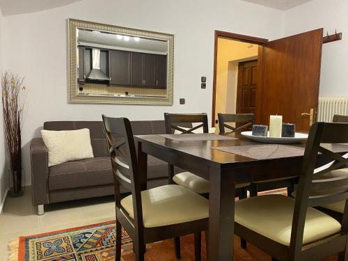 a dining room and living room with a table and chairs at Sarakinas Farm House in Kalabaka