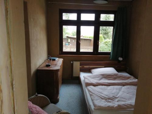 a small room with two beds and a window at Ferienhaus Caselow 23A in Bergholz