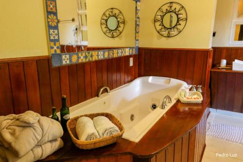 a bathroom with a bath tub with towels on a counter at Pousada Villa Luna in Penedo