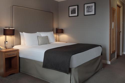 a bedroom with a large bed in a hotel room at The Worcester Whitehouse Hotel in Worcester