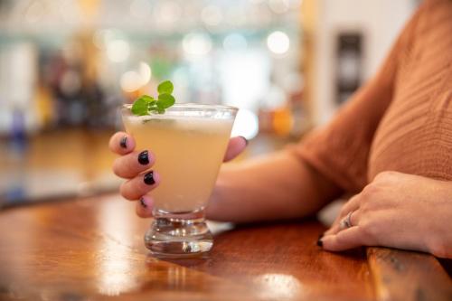 a woman sitting at a table with a drink at Chapter House in Yarmouth