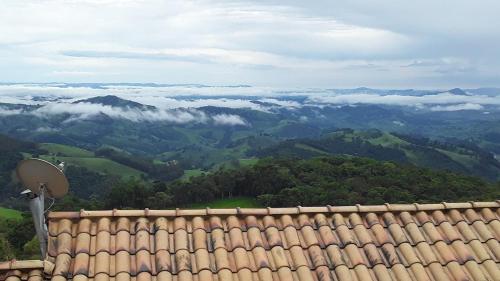 a view from the roof of a house with a view of mountains at Chalés Pôr do Sol in Gonçalves