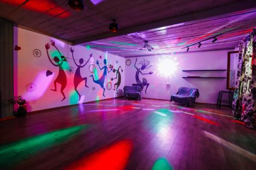 a room with a dance floor with neon lights at Laguna Villa - Pool, Sauna, Events - at Bazaleti Lake in Karsimaantkari
