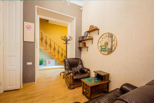 a living room with a couch and a chair and a table at Galaktioni 22 in Tbilisi City
