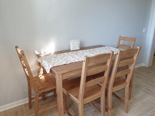 a wooden table with four chairs and a tablecloth on it at Best Apartment Truskavets in Truskavets