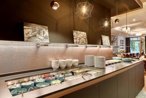 a buffet line with plates and dishes on display at Kurpension Freudenstein in Bad Füssing