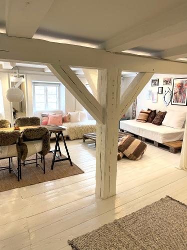 a living room with a table and a couch at A Charming and Beautiful Oasis in the Heart of Copenhagen in Copenhagen