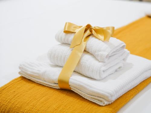 a stack of towels with a bow on top at Casa Napoletana - Culture Apartment in Naples