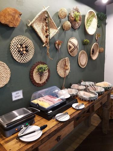 a table with baskets and other items on a wall at Pousada Aroeira in Barra do Sahy