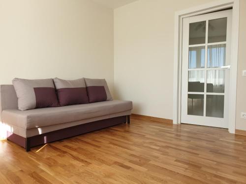 a couch in a living room with a wooden floor at Best Apartment Truskavets in Truskavets