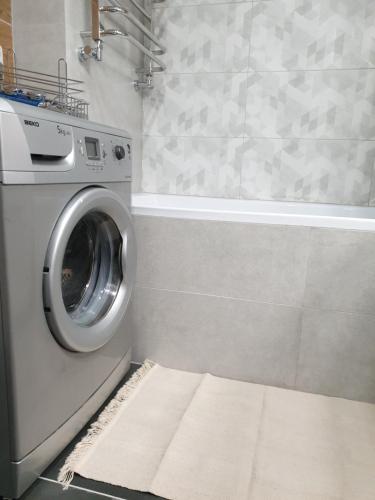 a laundry room with a washing machine in a bathroom at Best Apartment Truskavets in Truskavets