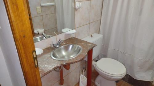 a bathroom with a sink and a toilet at La Casita in San Martín de los Andes