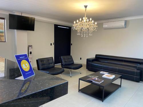 a living room with a couch and a table at Hotel Diamante in Sao Paulo