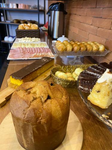 a table with many different types of pastries and cakes at Hotel Diamante in Sao Paulo