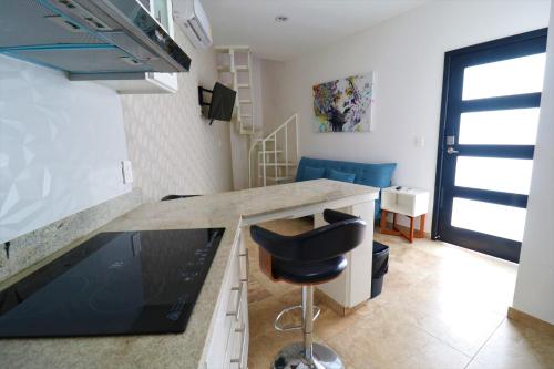 a kitchen with a counter and a stool in a room at Departamento Ibiza in La Paz