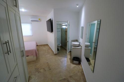 a bathroom with a bed and a sink and a toilet at Departamento Ibiza in La Paz