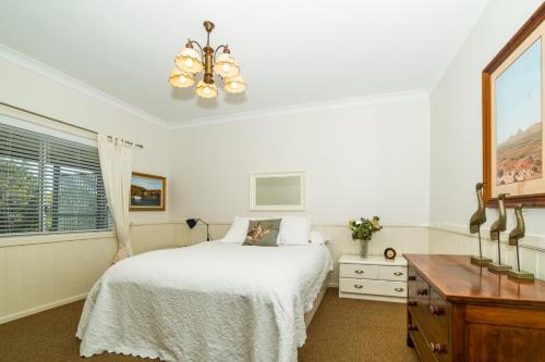 
a bedroom with a large bed and a large window at The Bryn at Tilba in Central Tilba
