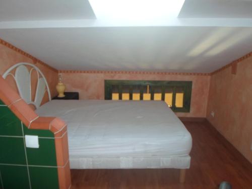 a bedroom with a white bed and a window at coquet f2 avec petite terrasse in Canet-en-Roussillon
