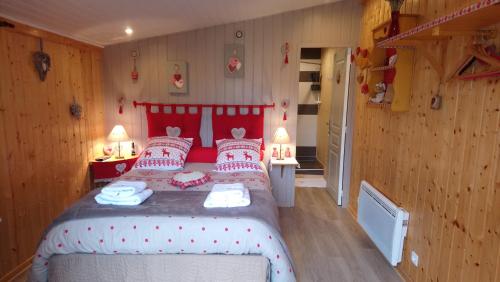 a bedroom with a bed with red and white pillows at Chambre D'hôte "Les Tourtereaux" in Saint-Just-de-Claix