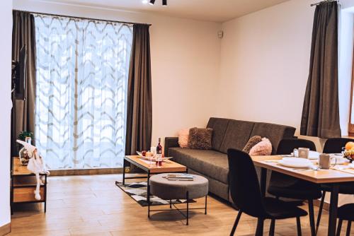 a living room with a couch and a table at MM LUCKY apartments in Demanovska Dolina