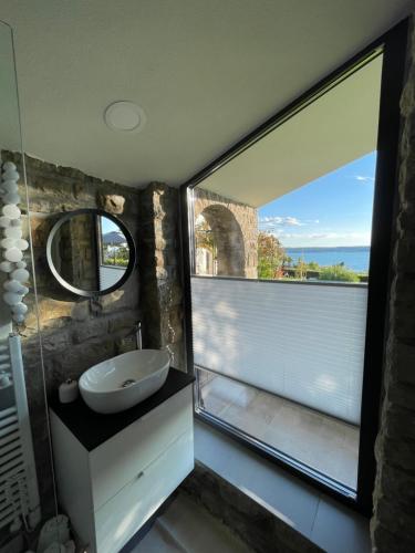 a bathroom with a sink and a large window at Studio Solare in Portorož